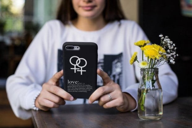 A handmade phone case with a print of the lesbian love sign and its meaning